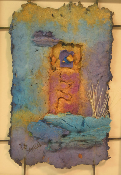 photo of handmade paper wall piece in shades of blue 12x16