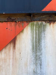 photograph of rusted metal with graffiti  