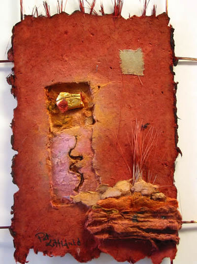 Handmade paper wall piece in shades of rust with lavender. 12x16