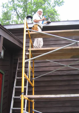 photo of Allen Littlefield on scaffold painting house