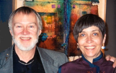 Photo of Allen and Pat Littlefield in front of one of Pat's paper collage pieces